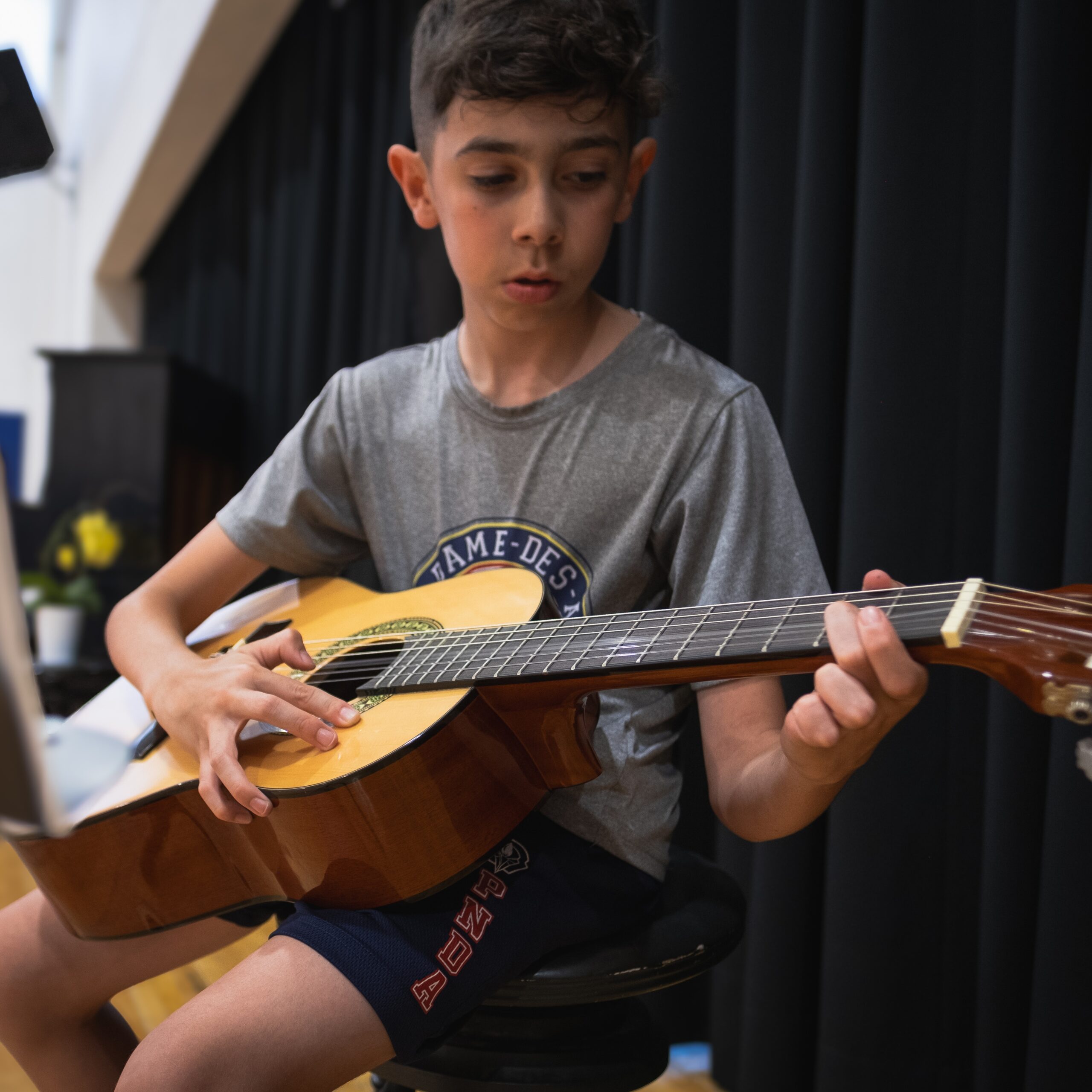 Arts plastiques et musique Enfant jouant de la guitare au Pensionnat Notre-Dame-des-Anges
